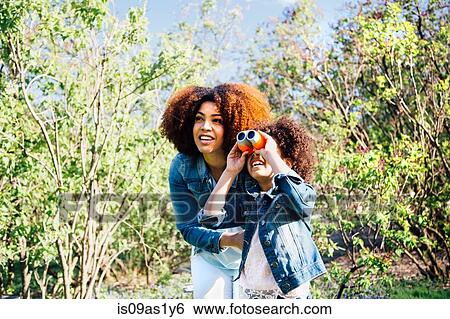 Mother and daughter using binoculars, looking up View Large Photo Image Stock Photograph - Mother and daughter using binoculars, looking up. Fotosearch