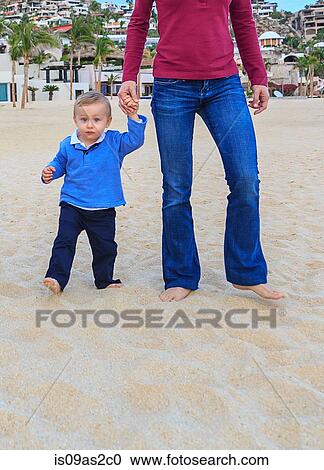Mother and son on beach, holding hands, low section View Large Photo Image Stock Image - Mother and son on beach, holding hands, low section. Fotosearch