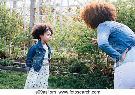 Mother scolding girl, hand on hip, pointing finger View Large Photo Image Picture - Mother scolding girl, hand on hip, pointing finger. Fotosearch