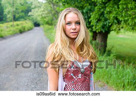 Portrait of fashionable young woman on rural road View Large Photo Image Stock Image - Portrait of fashionable young woman on rural road. Fotosearch