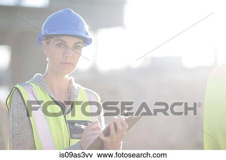 Portrait of female surveyor with clipboard on construction site View Large Photo Image Stock Photo - Portrait of female surveyor with clipboard on construction site. Fotosearch