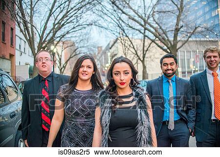 Portrait of four young adult friends on night out walking along street View Large Photo Image Stock Photography - Portrait of four young adult friends on night out walking along street. Fotosearch