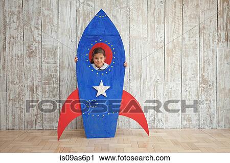 Portrait of girl looking from window of blue homemade cardboard rocket View Large Photo Image Stock Image - Portrait of girl looking from window of blue homemade cardboard rocket. Fotosearch
