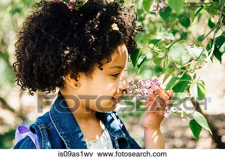 Portrait of girl smelling flowers, side view View Large Photo Image Stock Photo - Portrait of girl smelling flowers, side view. Fotosearch