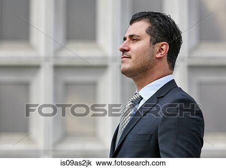 Stock Image - Portrait of mid adult business man looking away. side view. Fotosearch