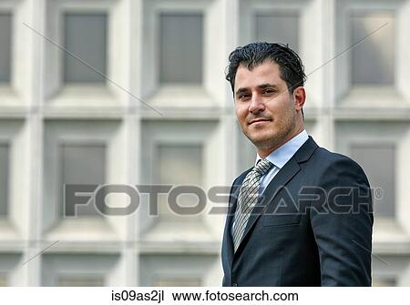 Stock Image - Portrait of mid adult business man looking at camera. Fotosearch