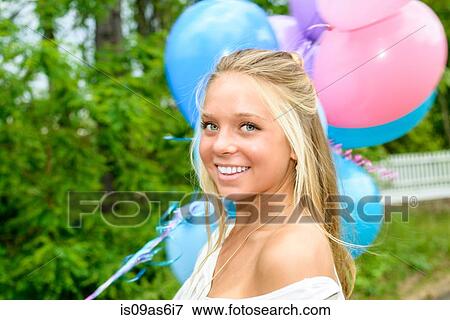 Portrait of pretty young woman with long blond hair holding bunch of balloons View Large Photo Image Stock Photo - Portrait of pretty young woman with long blond hair holding bunch of balloons. Fotosearch