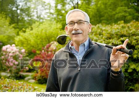 Portrait of senior man, holding golf club View Large Photo Image Stock Photo - Portrait of senior man, holding golf club. Fotosearch