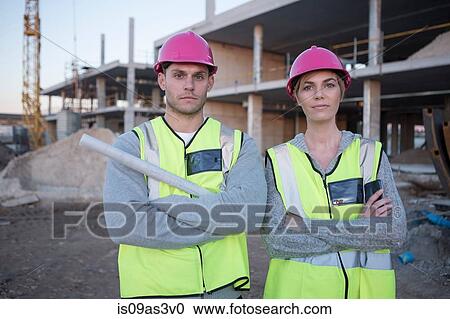 Stock Image - Portrait of surveyor and architect on construction site. Fotosearch