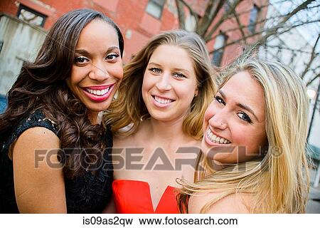 Portrait of three glamorous young adult female friends on street View Large Photo Image Stock Photo - Portrait of three glamorous young adult female friends on street. Fotosearch