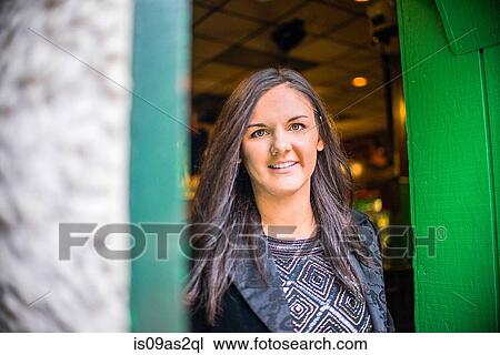 Portrait of young woman in green doorway View Large Photo Image Stock Image - Portrait of young woman in green doorway. Fotosearch