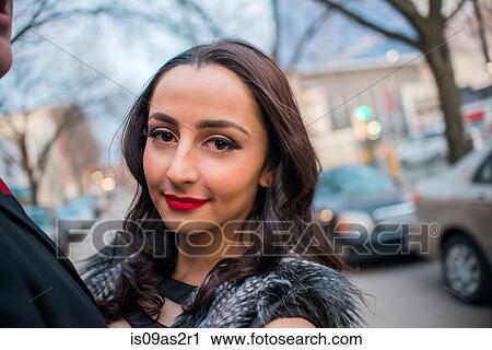 Portrait of young woman next to young man on street View Large Photo Image Stock Image - Portrait of young woman next to young man on street. Fotosearch
