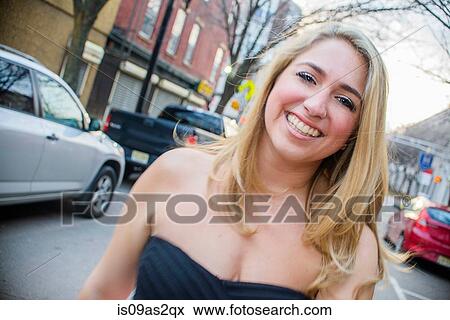 Stock Photo - Portrait of young woman on street. Fotosearch