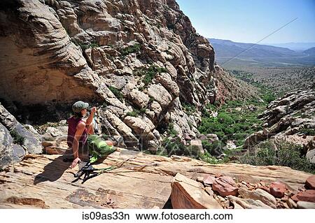 Rear view of hiker sitting looking out at view, First Creek, Las Vegas, Nevada, USA View Large Photo Image Picture - Rear view of hiker sitting looking out at view, First Creek, Las Vegas, Nevada, USA. Fotosearch