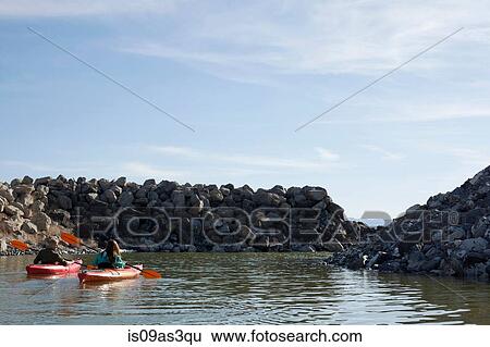 Rear view of kayakers sitting on water in kayaks facing rocks, Great Salt Lake, Utah, USA View Large Photo Image Stock Photograph - Rear view of kayakers sitting on water in kayaks facing rocks, Great Salt Lake, Utah, USA. Fotosearch