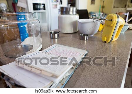 Stock Image - Recipe notes, hand mixer, mixing bowl and jar. Fotosearch