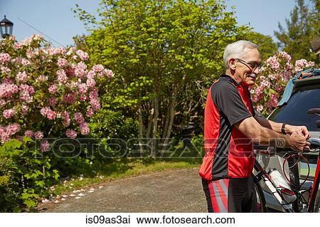 Senior man attaching bicycle to car View Large Photo Image Stock Image - Senior man attaching bicycle to car. Fotosearch