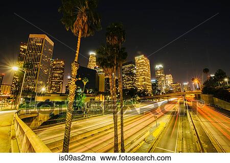 Stock Image - View of city skyline and highway at night, Los Angeles, California, USA. Fotosearch