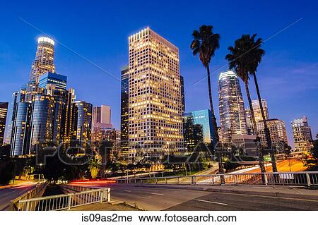 Stock Image - View of highway and city skyline at dusk, Los Angeles, California, USA. Fotosearch