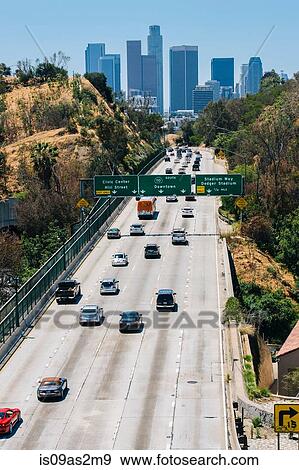 Stock Photo - View of highway and city skyline, Los Angeles, California, USA. Fotosearch