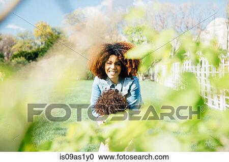 View through foliage of mother hugging daughter smiling View Large Photo Image Stock Image - View through foliage of mother hugging daughter smiling. Fotosearch