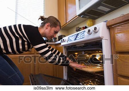 Picture - Woman baking in kitchen. Fotosearch