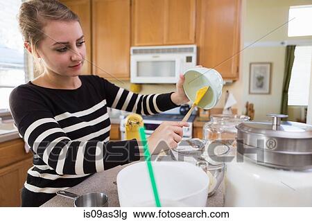 Stock Image - Woman baking in kitchen. Fotosearch