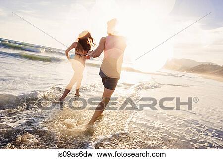 Young couple fooling around in sea View Large Photo Image Stock Photo - Young couple fooling around in sea. Fotosearch