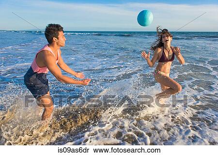 Stock Photography - Young couple fooling around in sea. Fotosearch