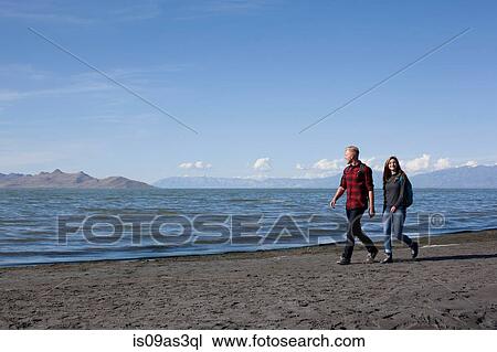 Young couple walking alongside waters edge, Great Salt Lake, Utah, USA View Large Photo Image Stock Image - Young couple walking alongside waters edge, Great Salt Lake, Utah, USA. Fotosearch