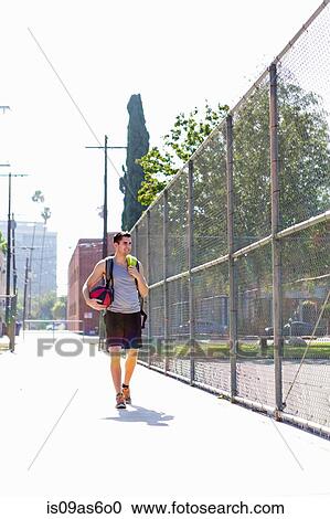 Young male basketball player walking to basketball practice View Large Photo Image Stock Image - Young male basketball player walking to basketball practice. Fotosearch