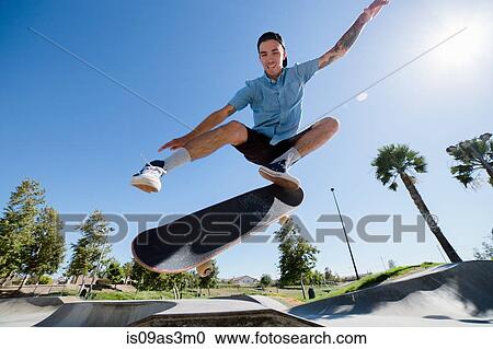 Young man skateboarding in park, Eastvale, California, USA View Large Photo Image Stock Image - Young man skateboarding in park, Eastvale, California, USA. Fotosearch