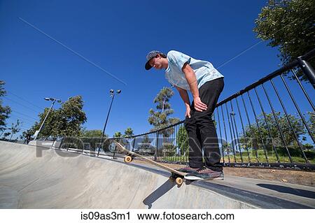 Stock Image - Young man skateboarding in park, Eastvale, California, USA. Fotosearch