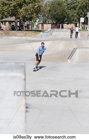 Stock Photo - Young man skateboarding in park, Eastvale, California, USA. Fotosearch