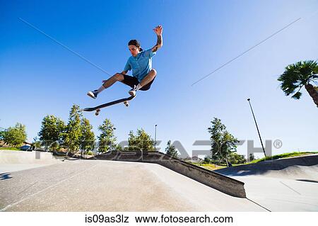 Young man skateboarding in park, Eastvale, California, USA View Large Photo Image Stock Photo - Young man skateboarding in park, Eastvale, California, USA. Fotosearch