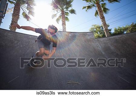 Stock Photograph - Young man skateboarding in park, Eastvale, California, USA. Fotosearch