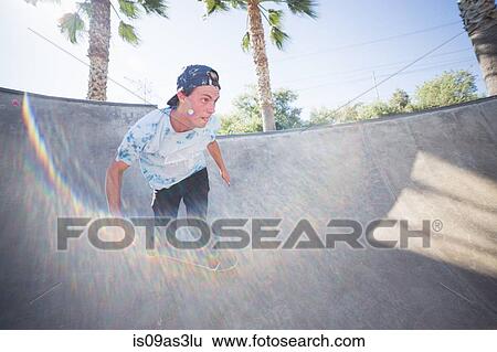 Stock Photograph - Young man skateboarding in park, Eastvale, California, USA. Fotosearch