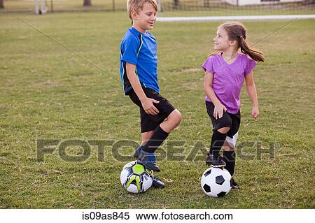 Boy and younger sister with footballs on practice pitch View Large Photo Image Stock Photography - Boy and younger sister with footballs on practice pitch. Fotosearch