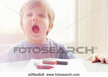Boy at table with crayons, looking at camera, open mouthed View Large Photo Image Stock Photo - Boy at table with crayons, looking at camera, open mouthed. Fotosearch