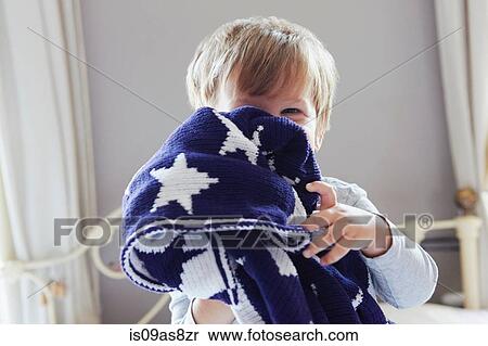 Boy on bed hiding behind navy blue star patterned woollen blanket View Large Photo Image Stock Photography - Boy on bed hiding behind navy blue star patterned woollen blanket. Fotosearch
