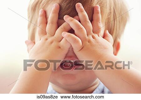 Cropped portrait of young boy covering his eyes with his hands View Large Photo Image Stock Image - Cropped portrait of young boy covering his eyes with his hands. Fotosearch