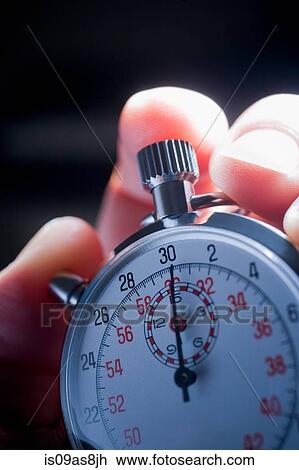Cropped shot of hand holding silver stop watch View Large Photo Image Stock Image - Cropped shot of hand holding silver stop watch. Fotosearch