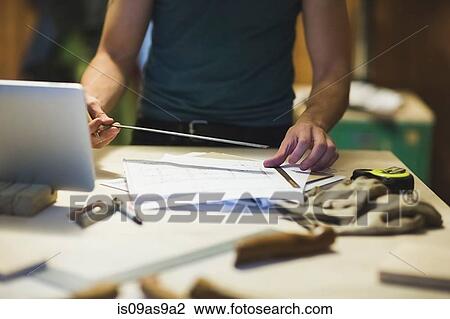 Cropped view of young mans hands using ruler View Large Photo Image Stock Image - Cropped view of young mans hands using ruler. Fotosearch