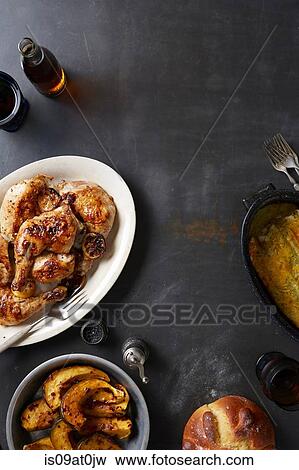 Stock Photo - 'Day of the Dead' food with roasted chicken and mole poblano sauce, acorn squash and enchiladas. Fotosearch