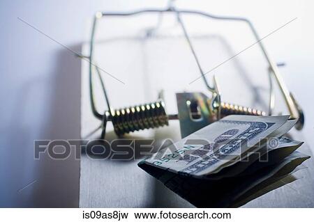 Stock Photo - Folded one hundred dollar bill in set mousetrap. Fotosearch