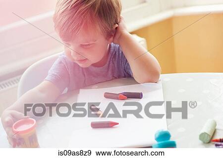 High angle view of boy sitting at table with art supplies View Large Photo Image Stock Photo - High angle view of boy sitting at table with art supplies. Fotosearch