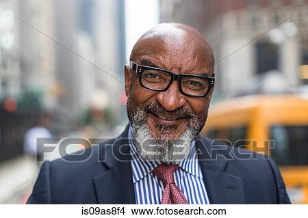 Picture - Mature businessman on street. Fotosearch