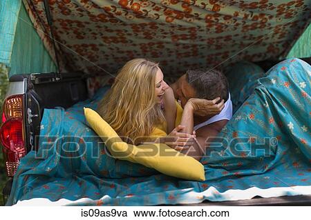 Mature man and girlfriend lying in pick up boot whilst camping View Large Photo Image Stock Image - Mature man and girlfriend lying in pick up boot whilst camping. Fotosearch