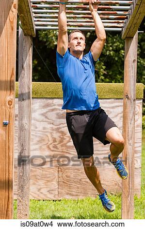 Mid adult man, working out, outdoors View Large Photo Image Picture - Mid adult man, working out, outdoors. Fotosearch