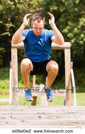 Mid adult man, working out, outdoors View Large Photo Image Stock Image - Mid adult man, working out, outdoors. Fotosearch